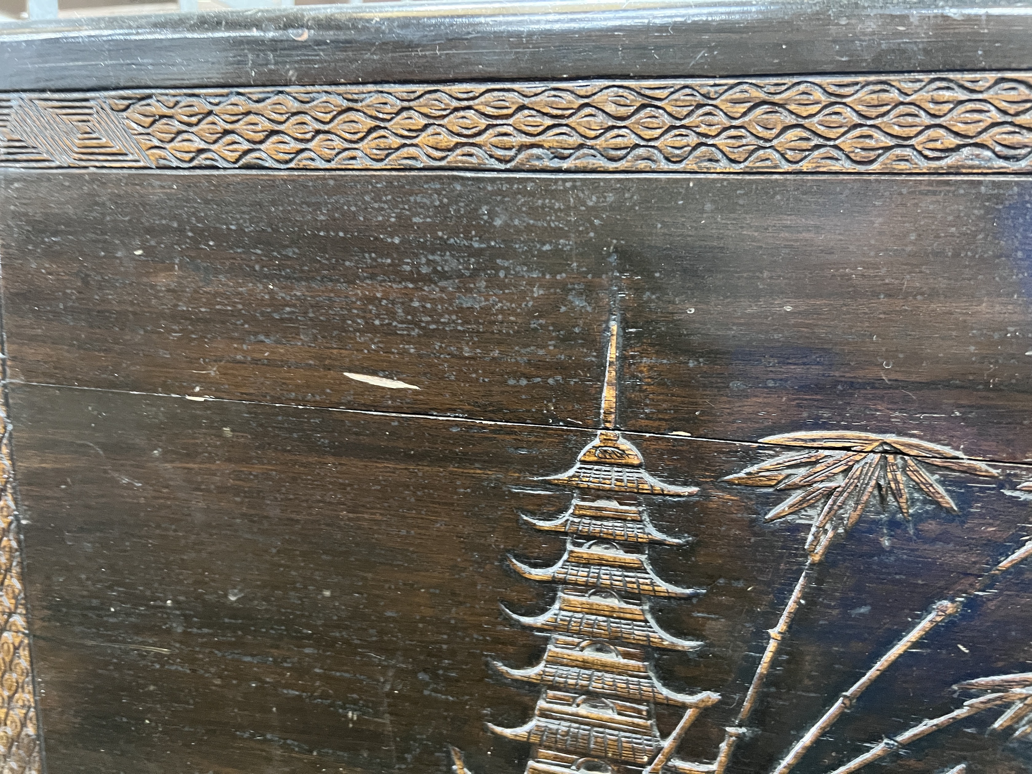 A Chinese carved camphorwood trunk, width 104cm, depth 54cm, height 66cm
